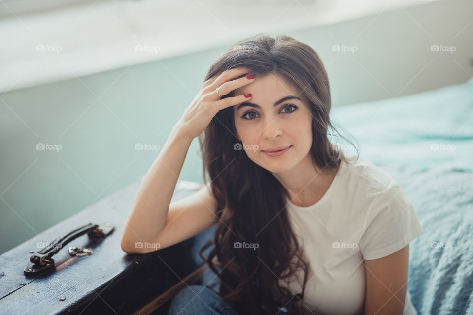 Beautiful young woman at home in daylight 