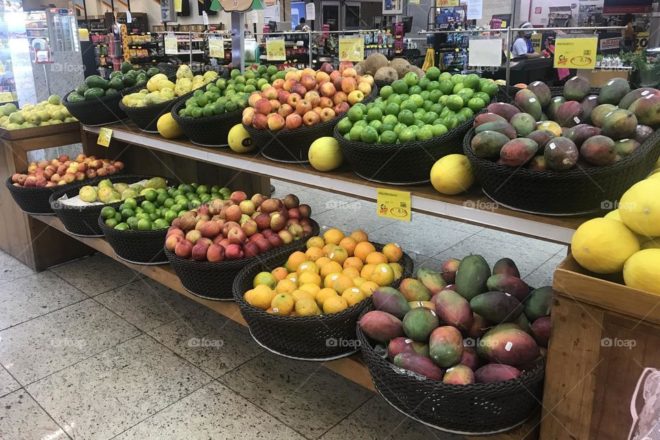 A section of the produce area in a Brazilian supermarket with lots of fresh tropical fruits. 