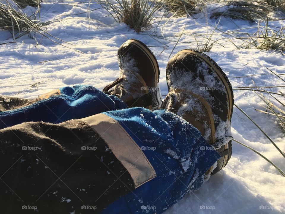 Feet laying on snow