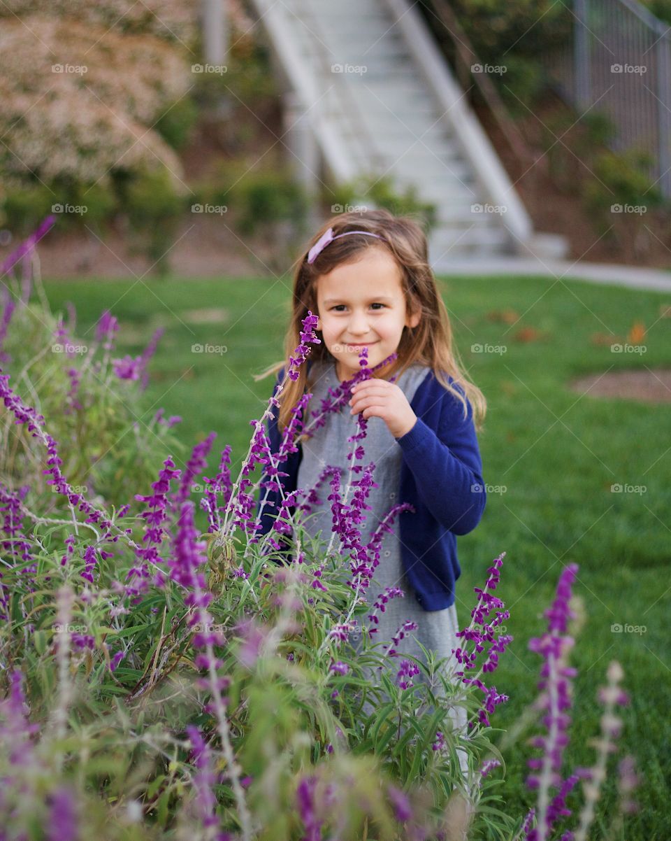 Beautiful girl smelling the flowers