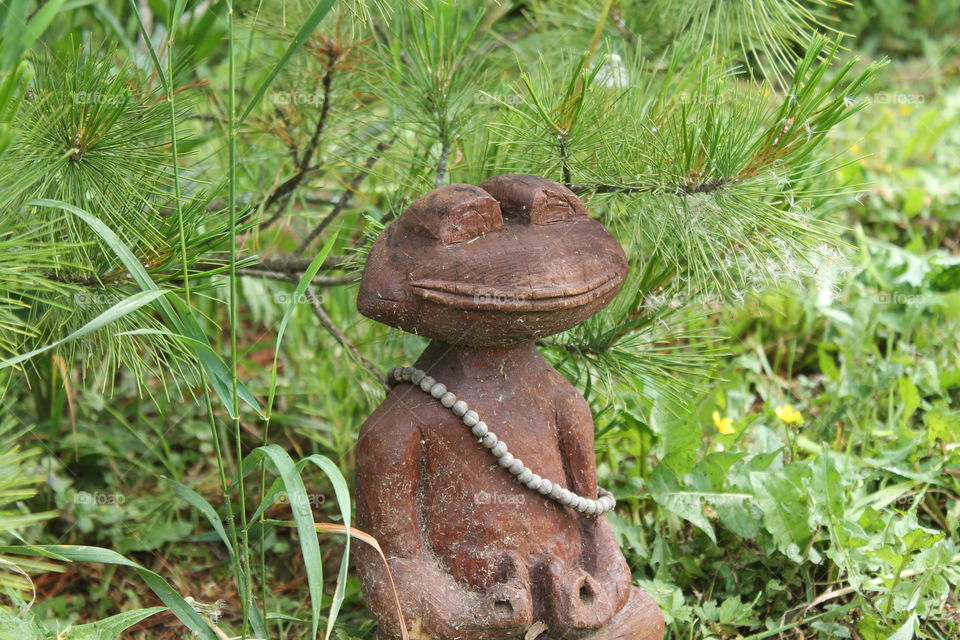 Wooden frog in my garden. I carved it few years ago... Its like a monach.