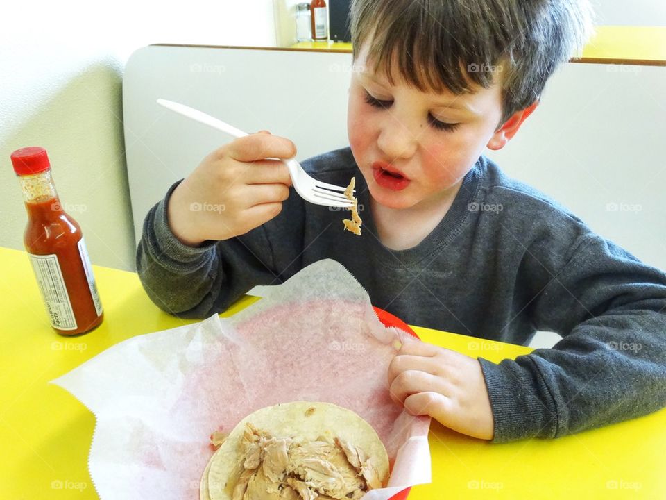 Young Boy Eating Lunch
