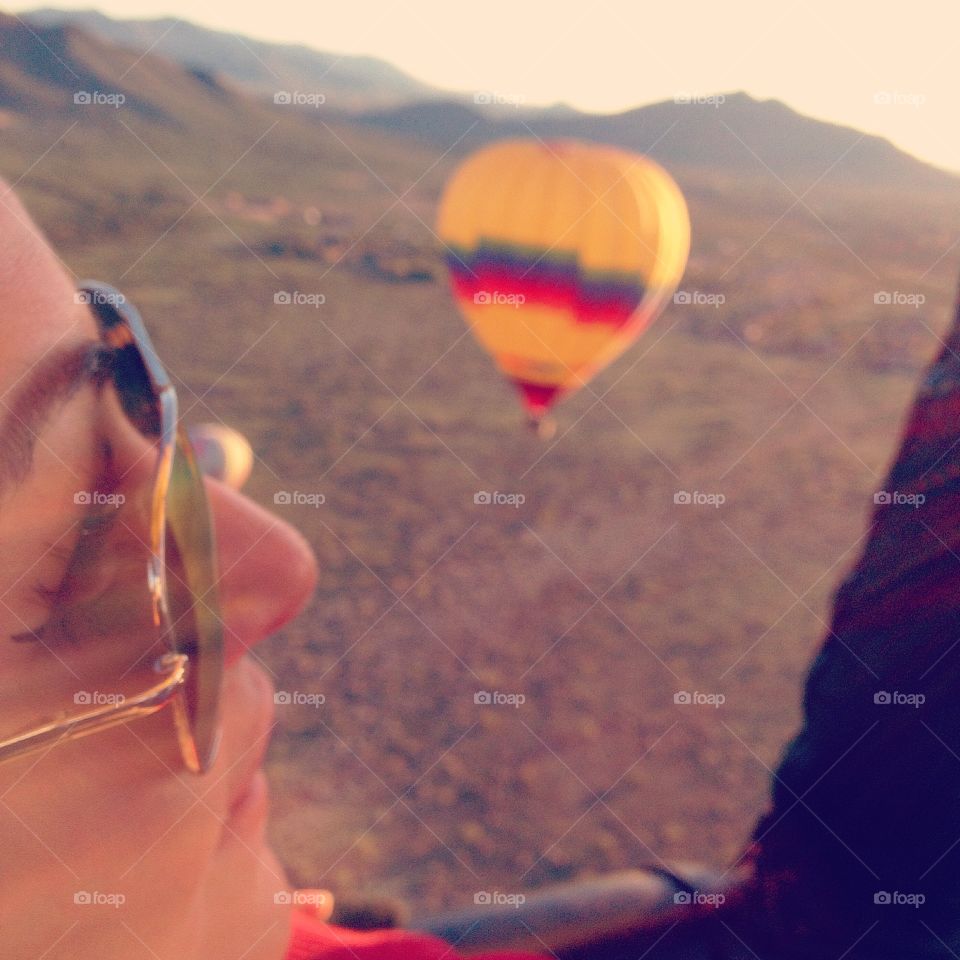 Mid hot air balloon flight. Capturing a passenger during flight.