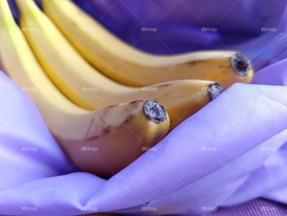 yellow bananas in purple bag.