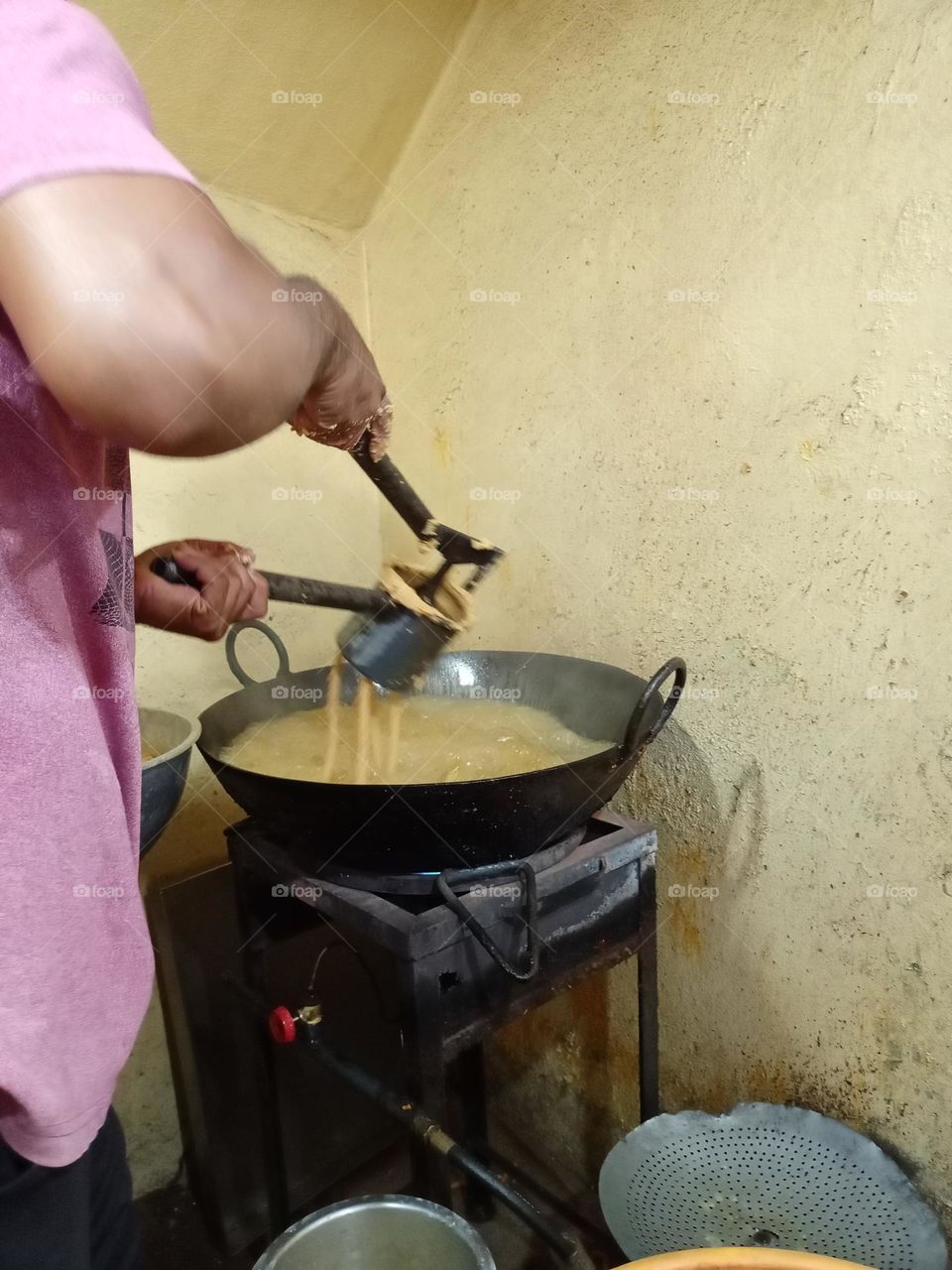 a worker making a chakli chakli is a savoury snack from India made from flours of rice it's tasti snacks