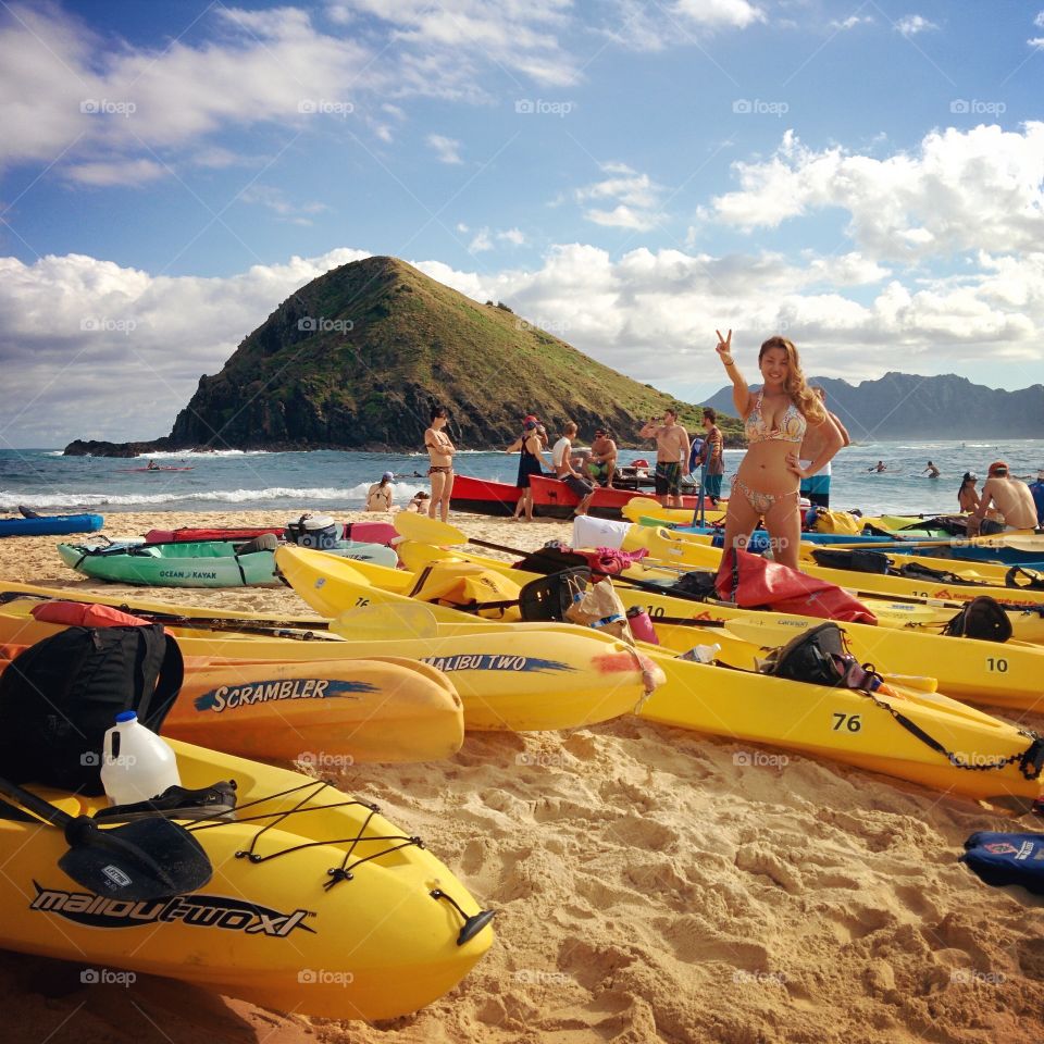 Woman in bikini gesturing at the sea
