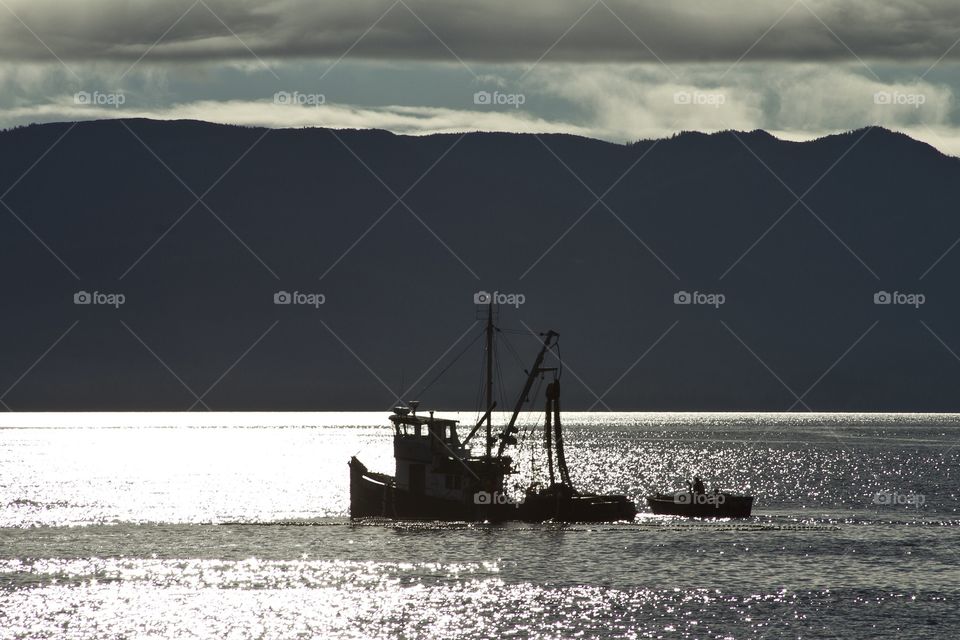 Fishing boat at sunset in the Alaskan sea 