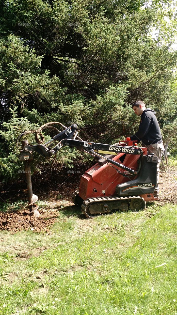 ditch witch digger. digging fence post holes