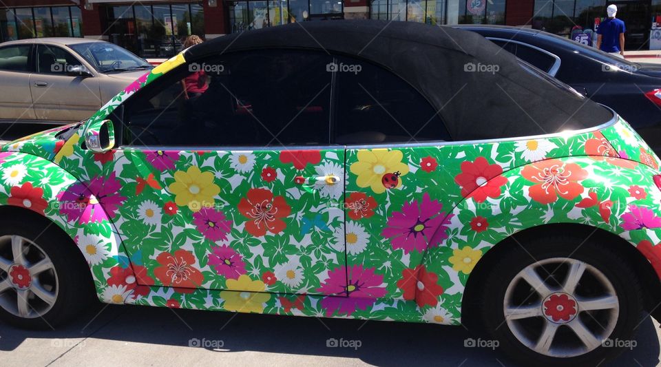 Spring fever. Volkswagen Beetle painted with flowers and ladybugs