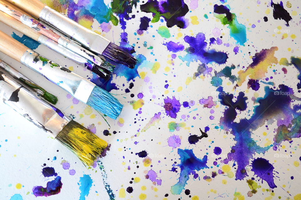 High angle view of paintbrushes against white background