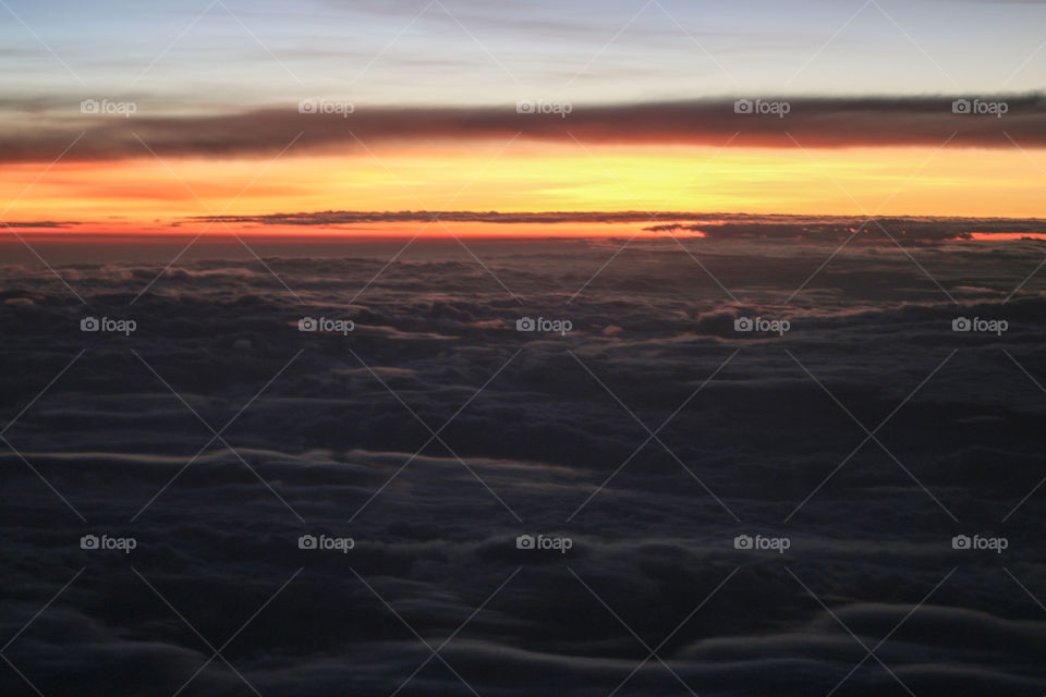 Sunrise over clouds. Sunrise shot from the plane window