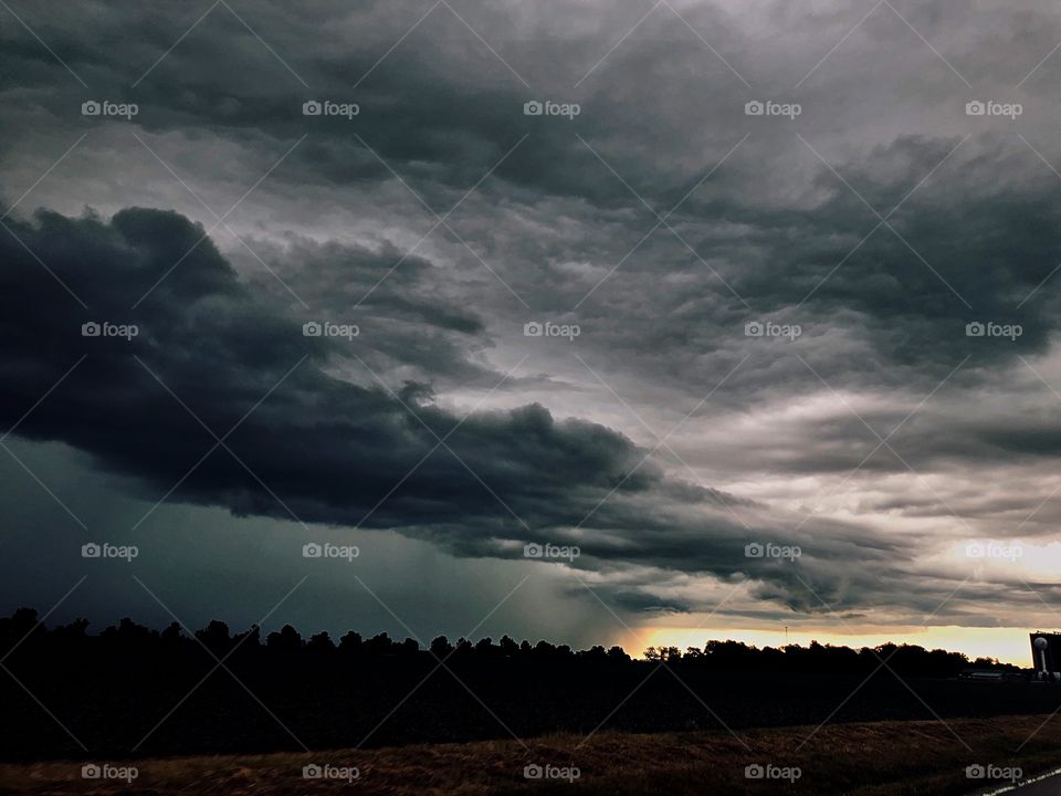A dramatic midwestern thunderstorm in the early morning rolling across a cornfield 