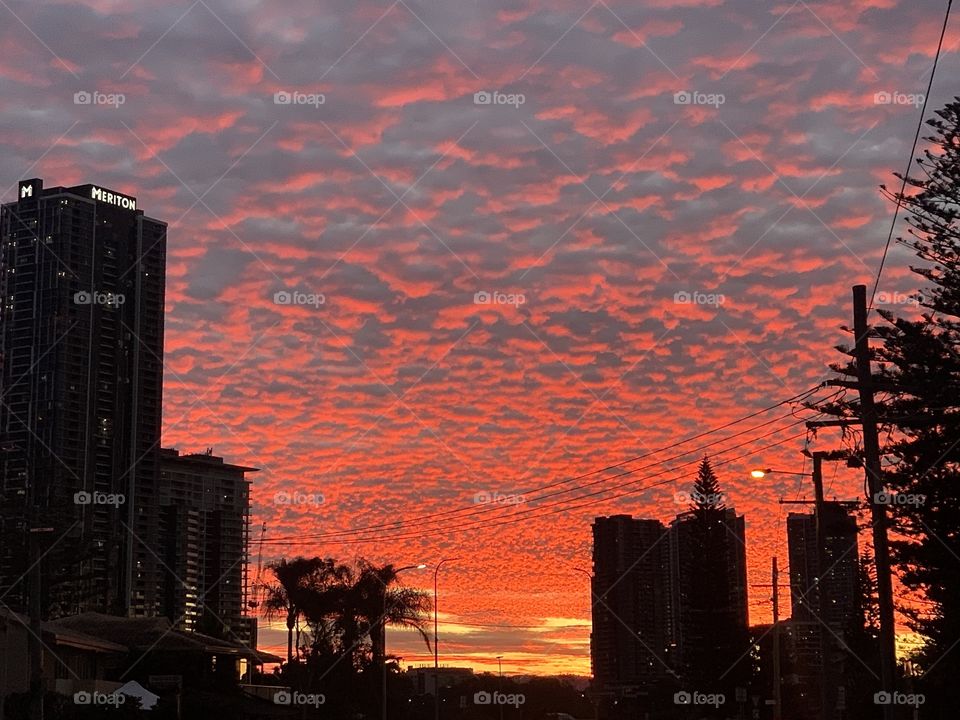 The sun sets beyond the rippled clouds creating a mesmerising fire and smoke effect. 