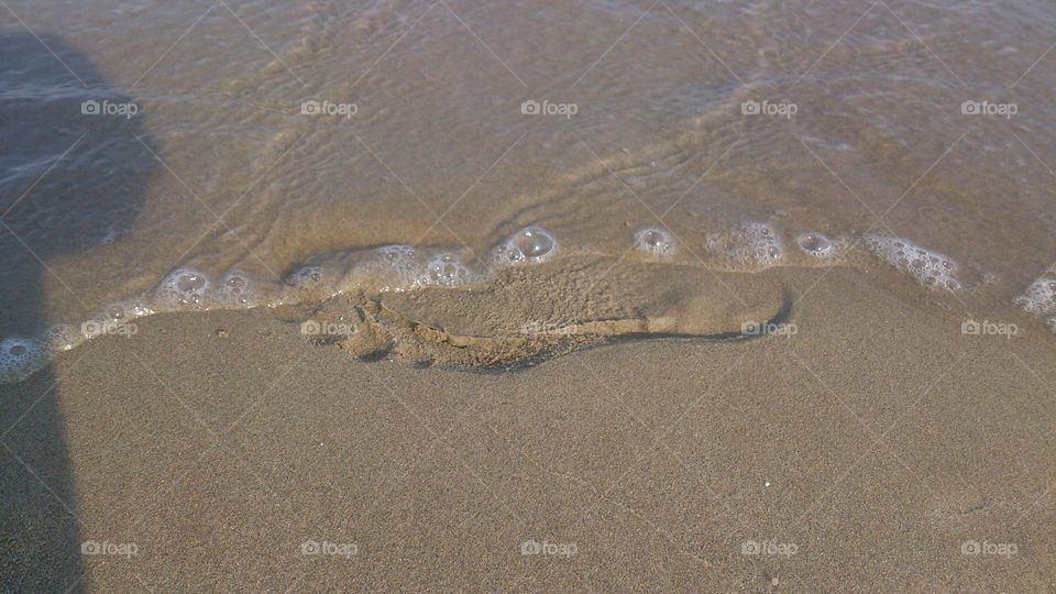 Huella pie en la arena