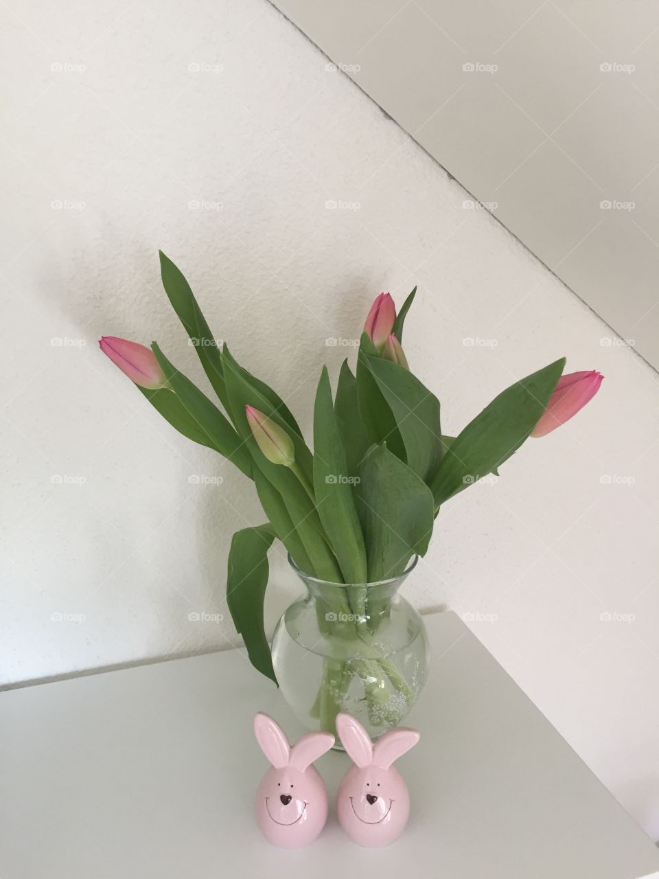 Easter time - tulips and easter bunny on the shelf 