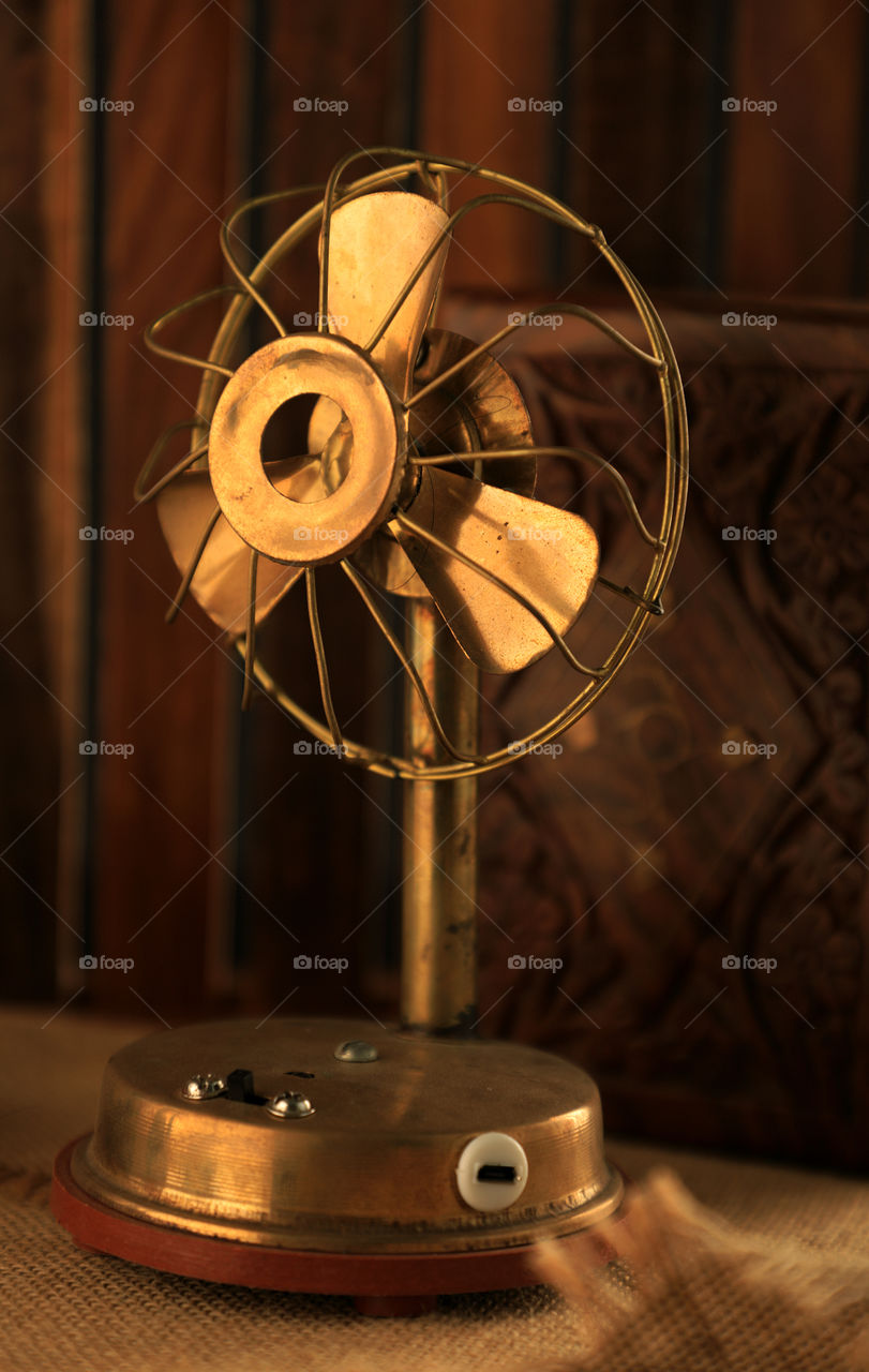 old Antique metal fan on wooden background