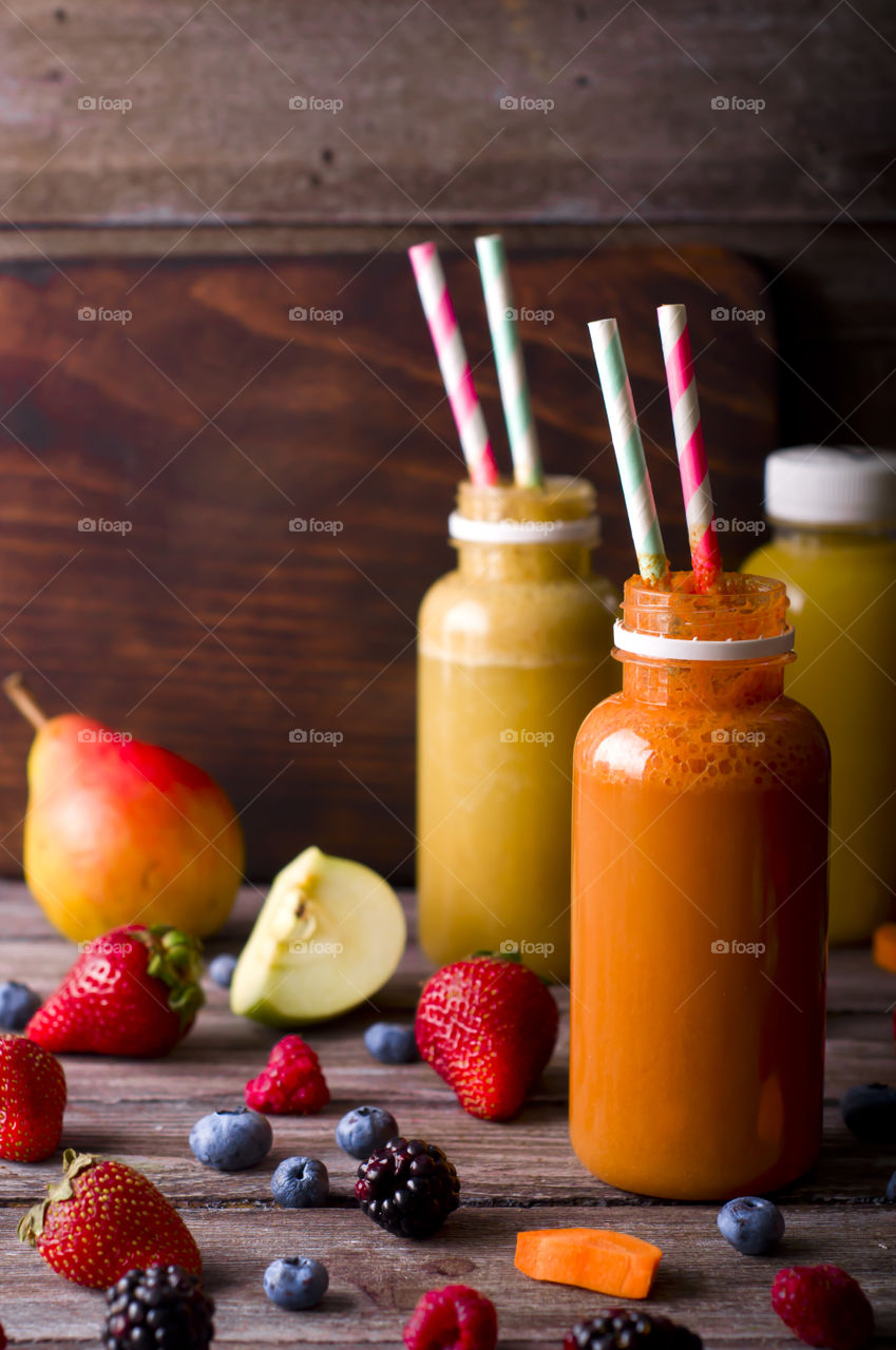 Delicious fruits smoothie in a jar with straw