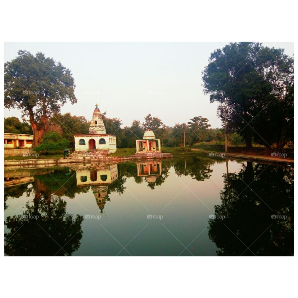 a old temple in india perfect reflection on water