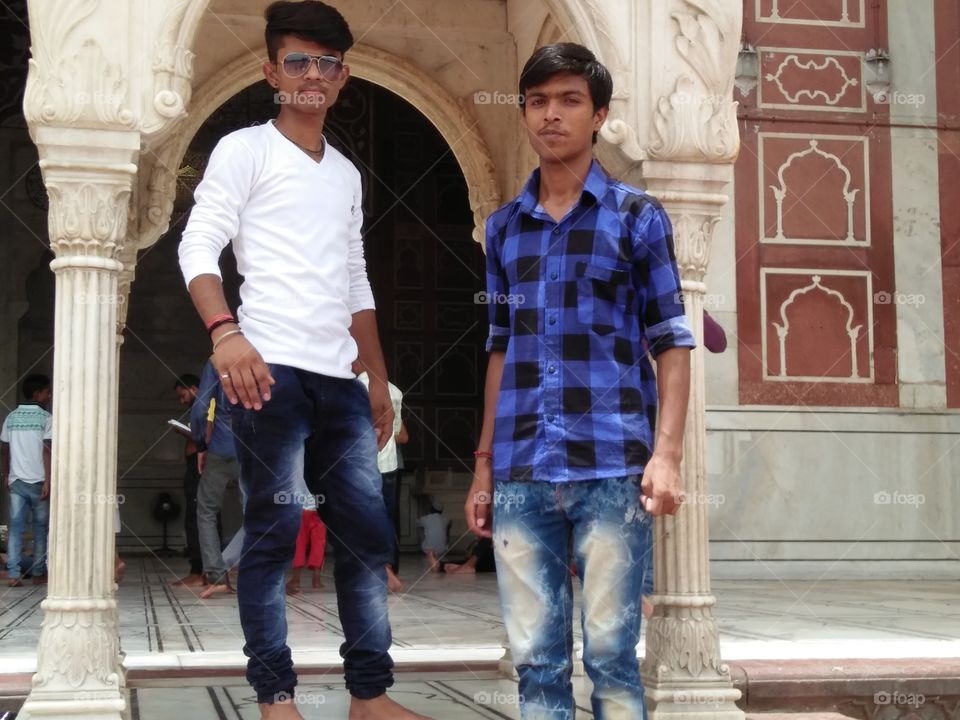 Indian teenage friends standing in temple