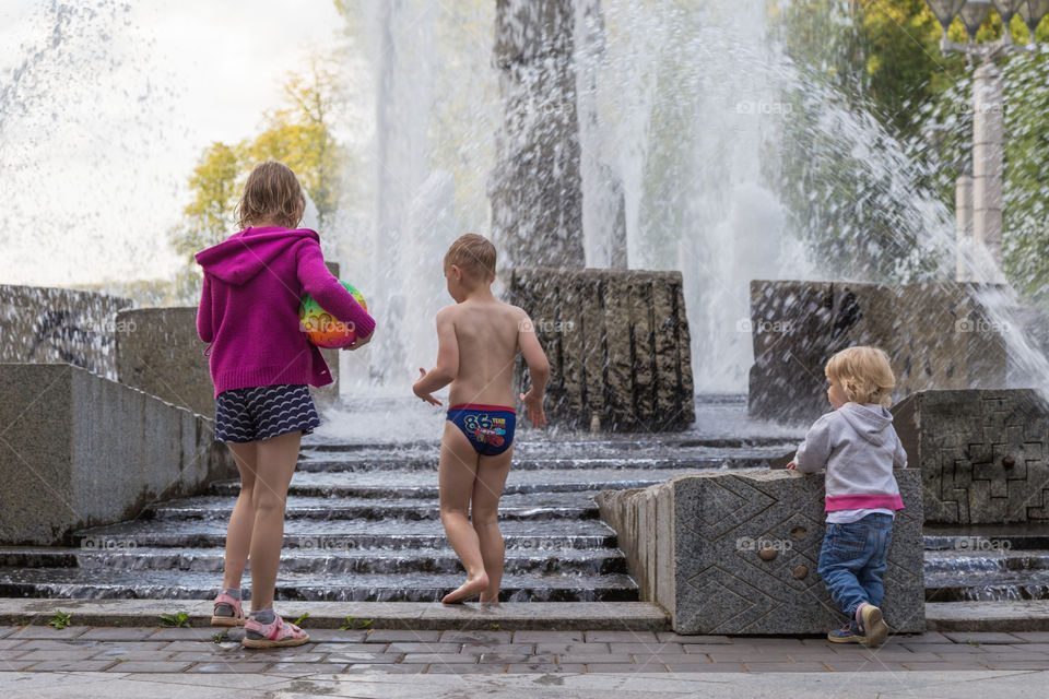 children playing in fountain