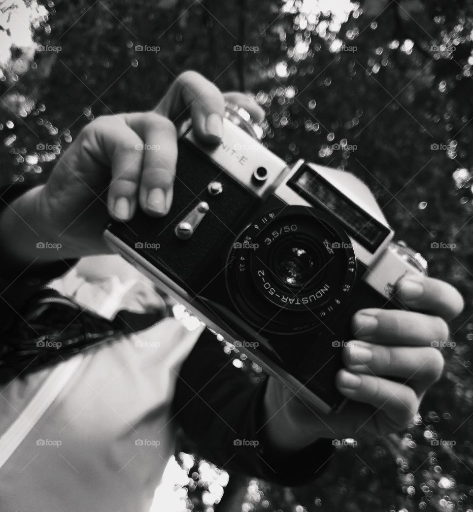analog camera in hands black and white
