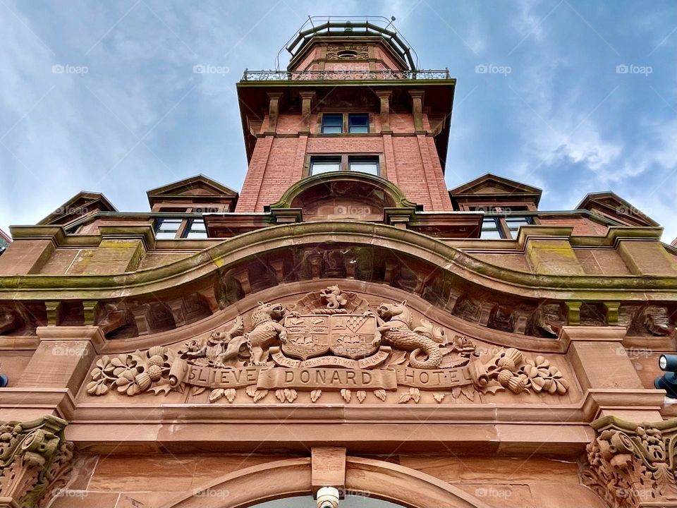 Looking up at the facade over the entrance of the Slieve Donard Hotel in Newcastle, Northern Ireland.