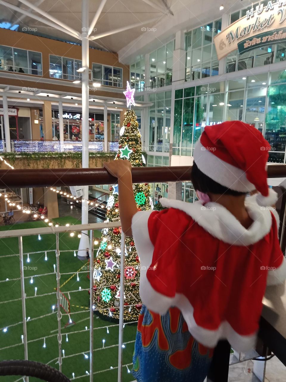 Kid looking at the Christmas tree