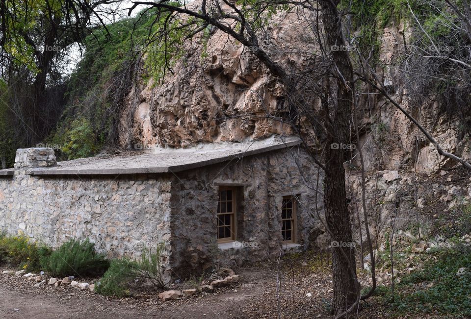 A stone cabin is erected as part of the hillside for strength and shelter