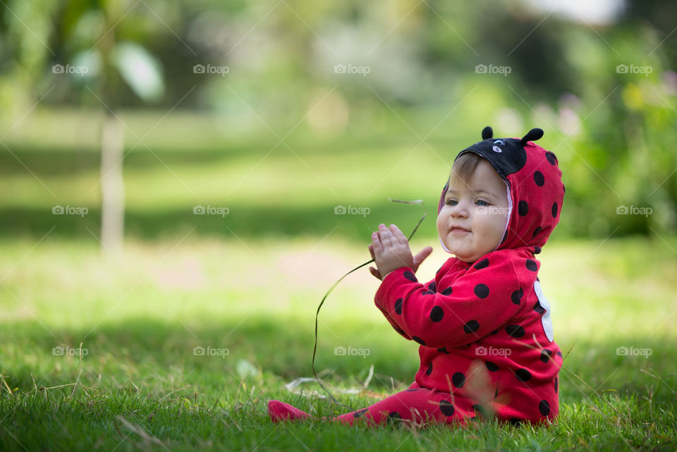 Baby girl in a lady bug costume