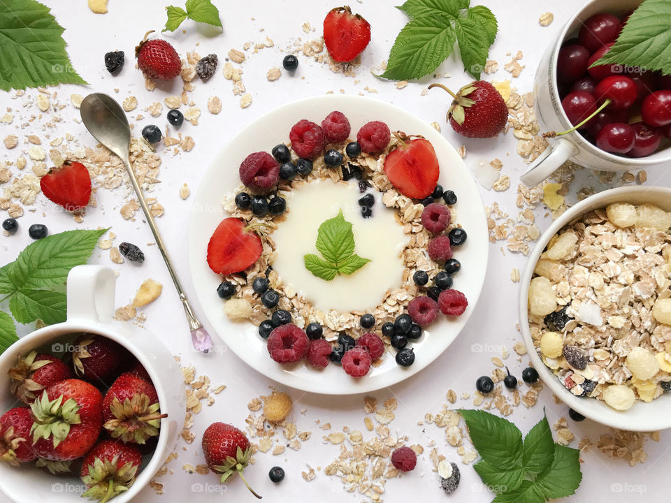 Colorful flat lay healthy breakfast - yogurt with muesli and fresh berries 
