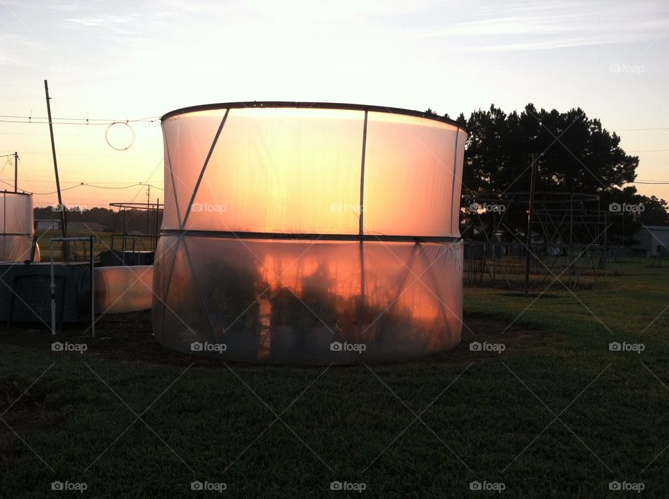 Sun rising behind an open top chamber