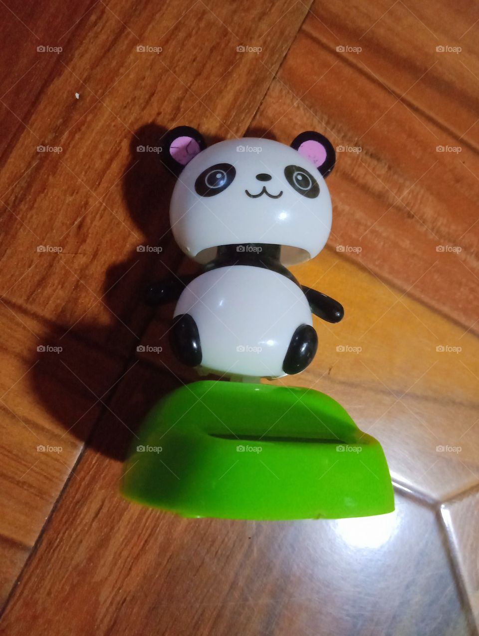 A panda toy is on the floor