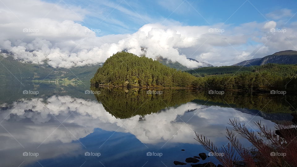 Perfect reflexion of the mountain in the fjord. Norway.