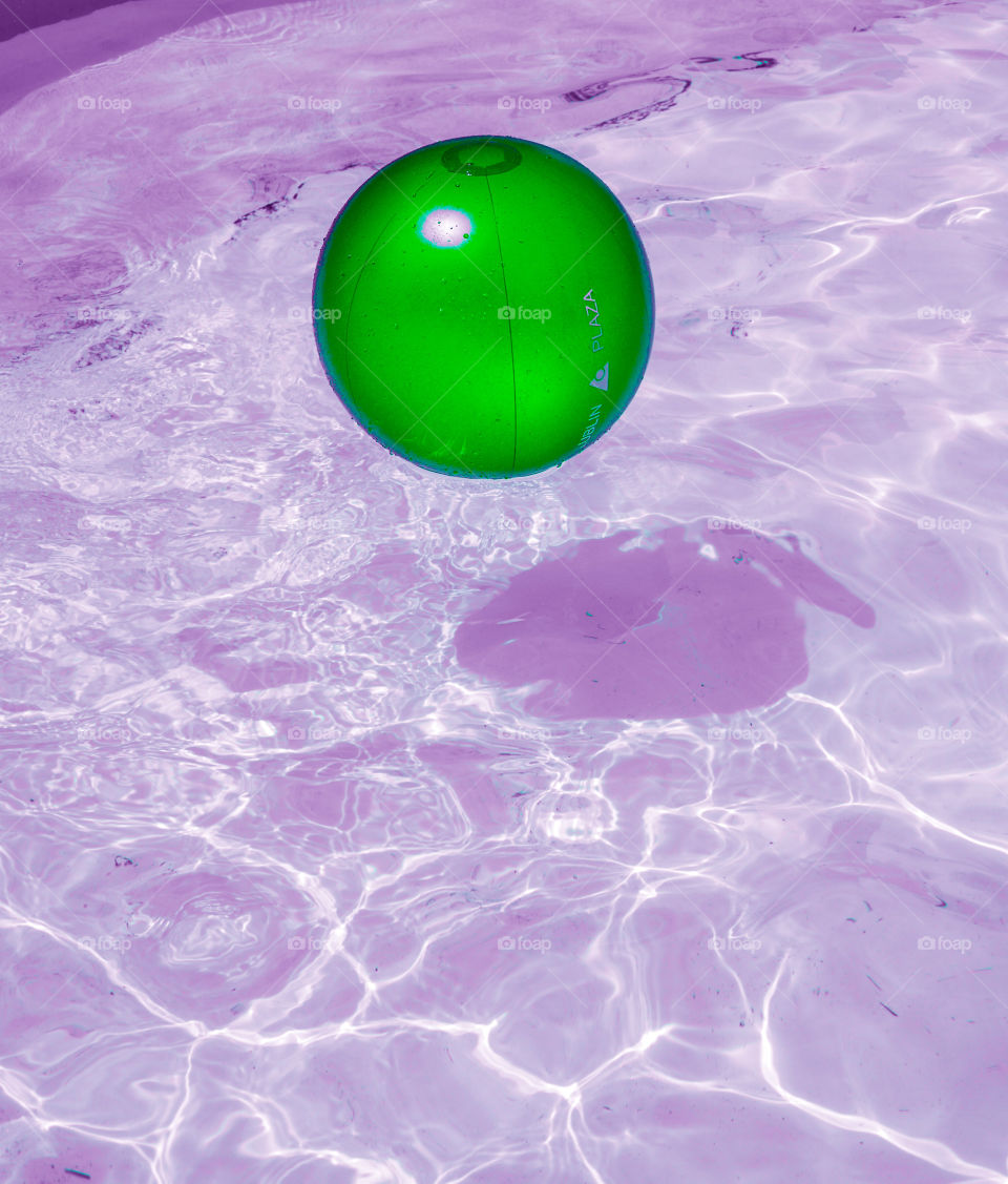Green ball floating on water