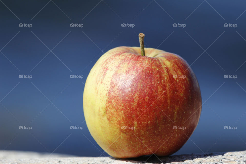 Apple on the rocks by the sea