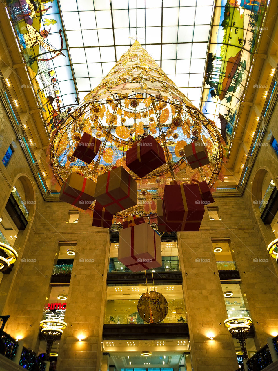 Christmas decoration Christmas tree with gifts suspended from the ceiling in a shopping center