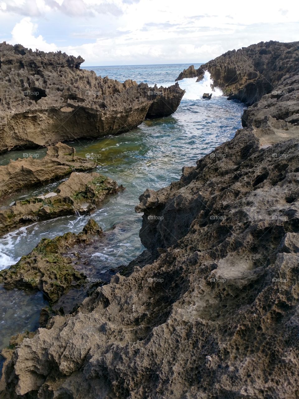 Natural water channel with waves rolling in at Manati Beach, PR.