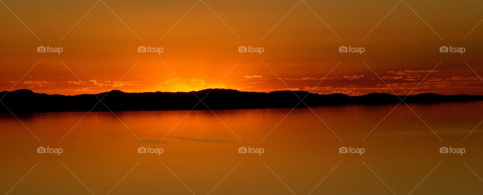 panoramic of Stansburry Island at sunset in the middle of the Great Salt Lake in Utah. taken from Antilope Island, also in the middle of the Great Salt Lake.