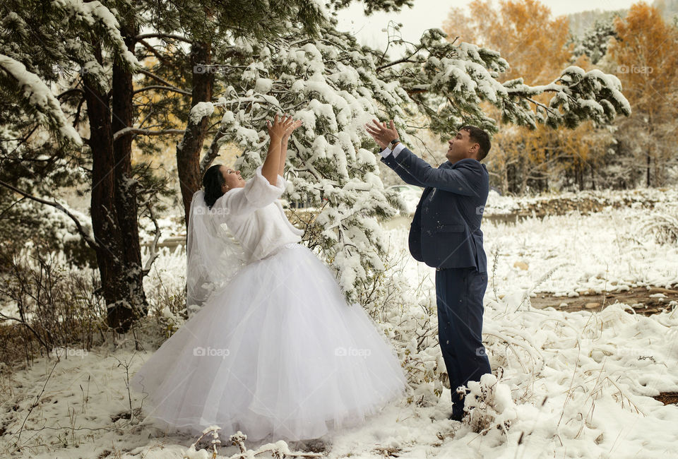Beautiful wedding couple on snow during winter