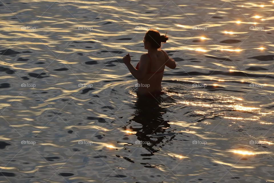 Refreshing in the ocean on golden hour