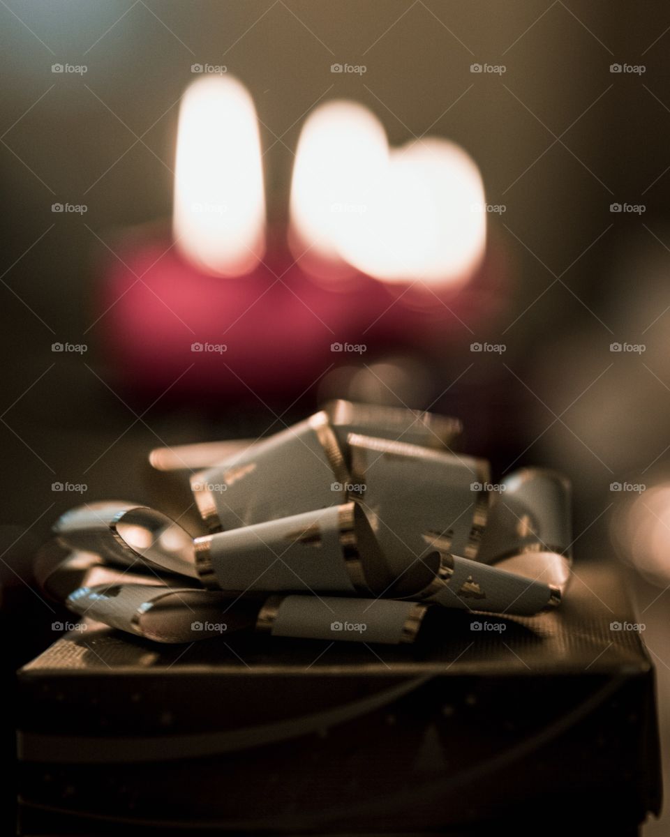Present in front of candlelights 