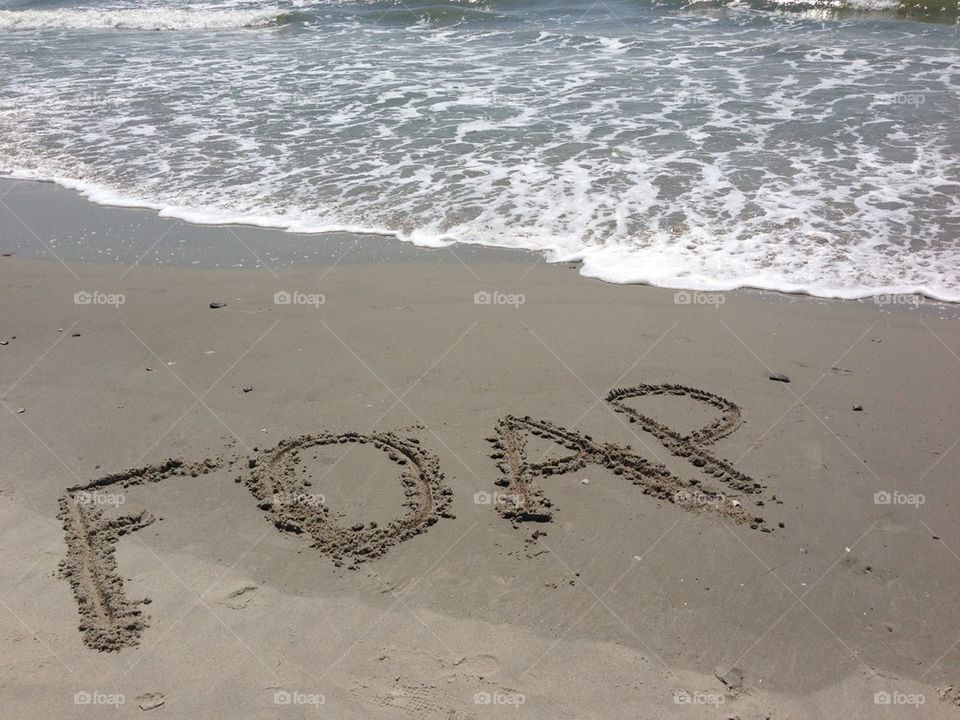 F OAP written in the sand