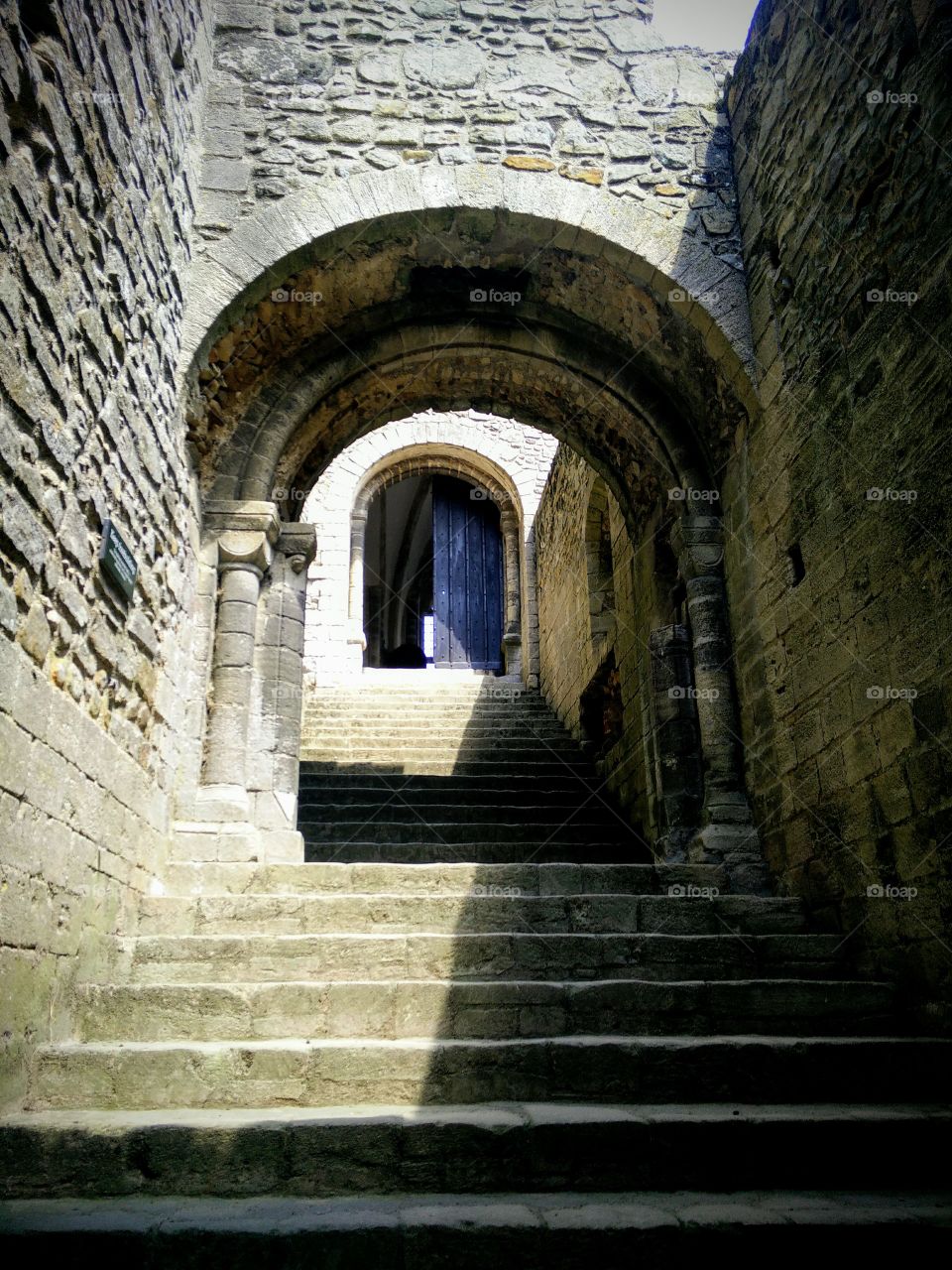 Entrance to ruins of Castle Rising medieval castle in the UK looking up steps
