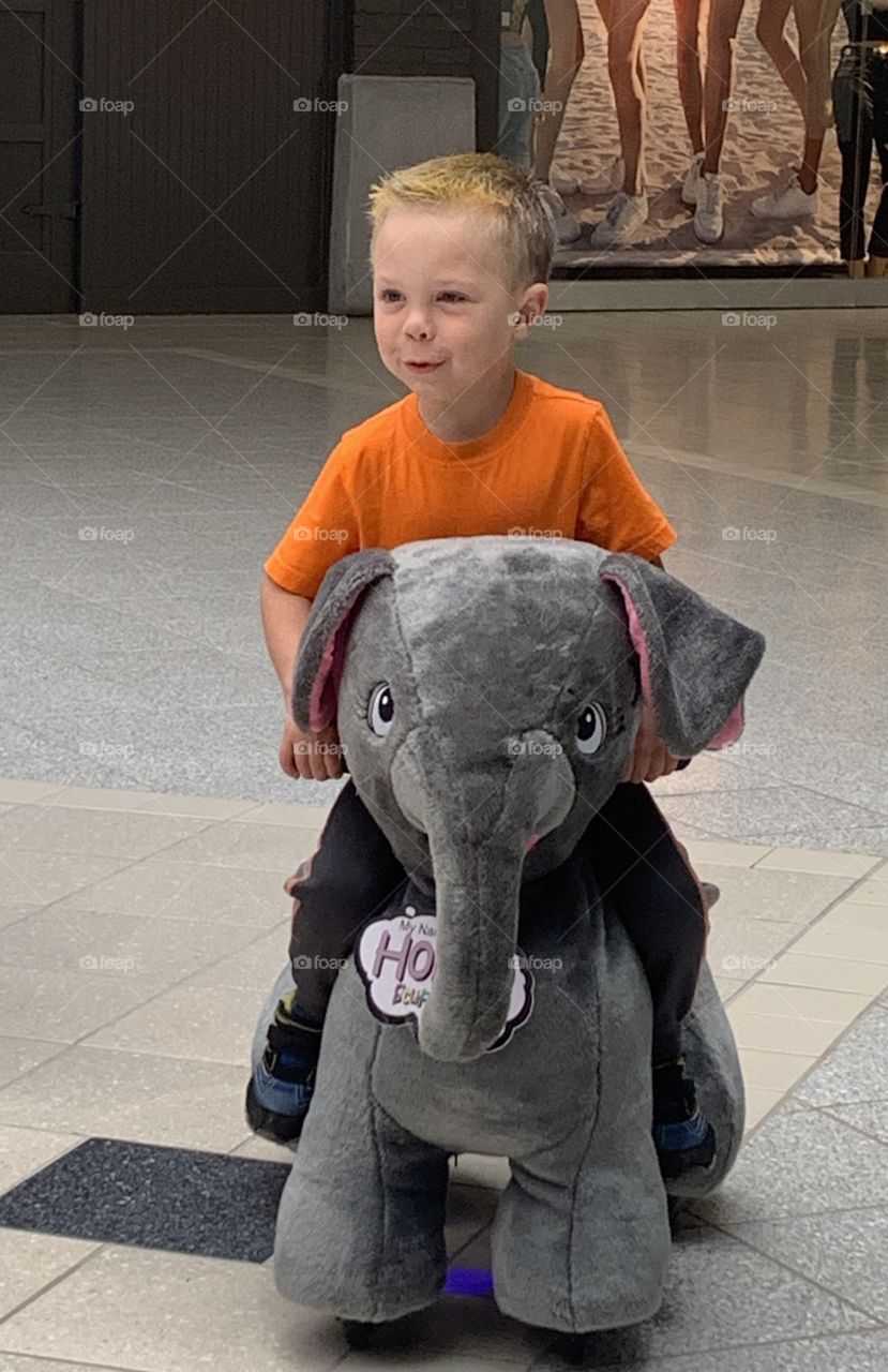 Riding a plush toy at the mall 