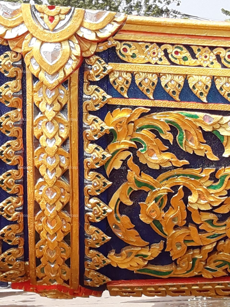close view of the body of "Royal Barge Suphannahong Model" carved with gilded lacquer and mirrored glass decoration. The identity of art of Thailand , exquisite craftwork.