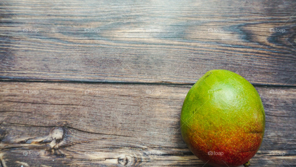 mango fruit on wooden background