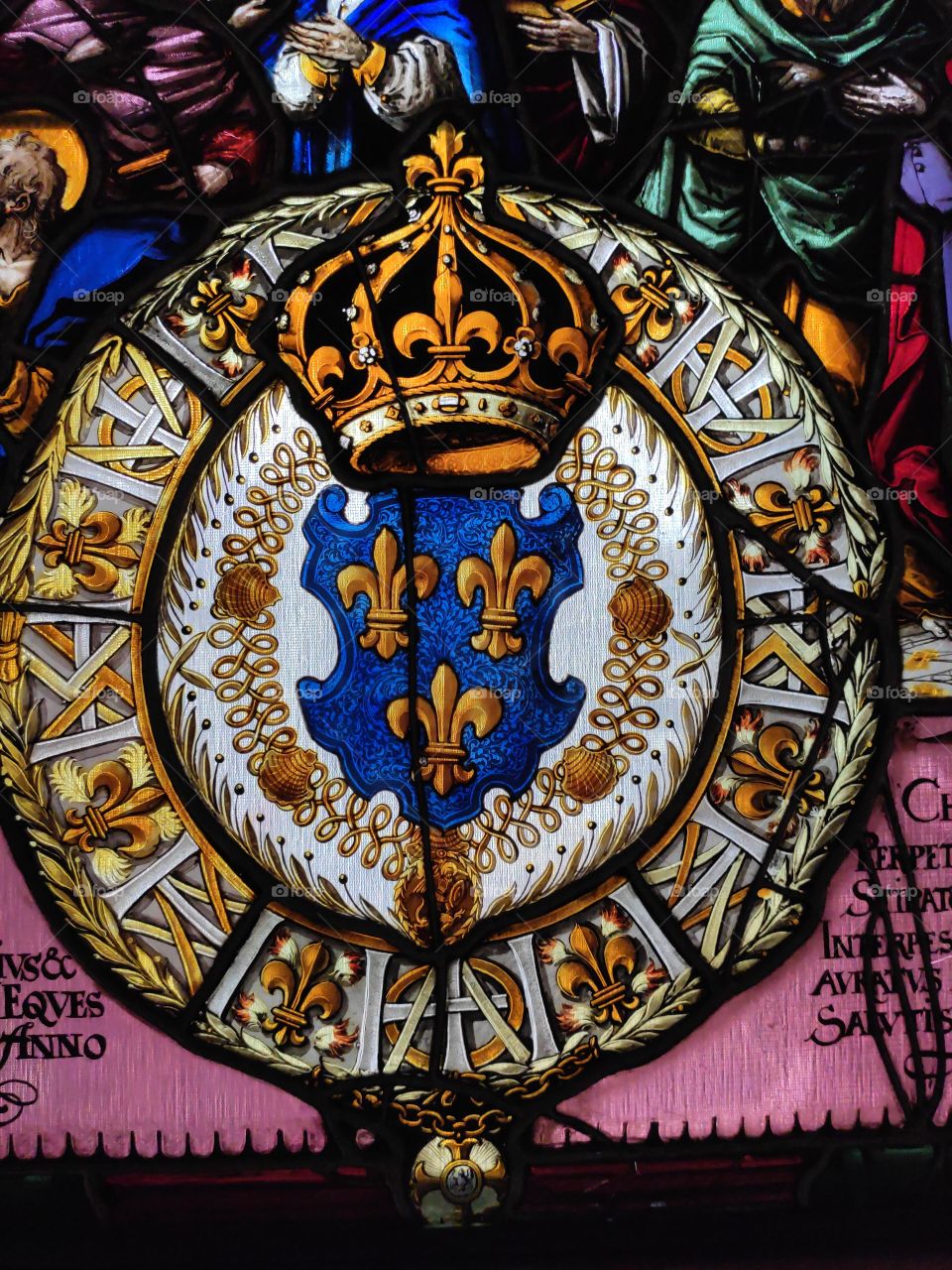 Stained glass crown and coat of arms with lilies