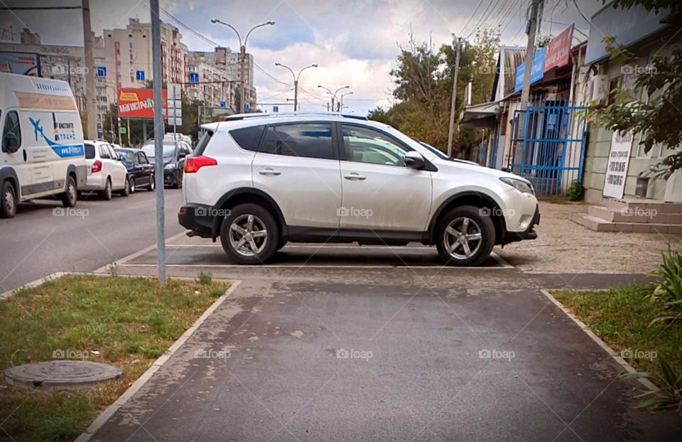 white car in city parking