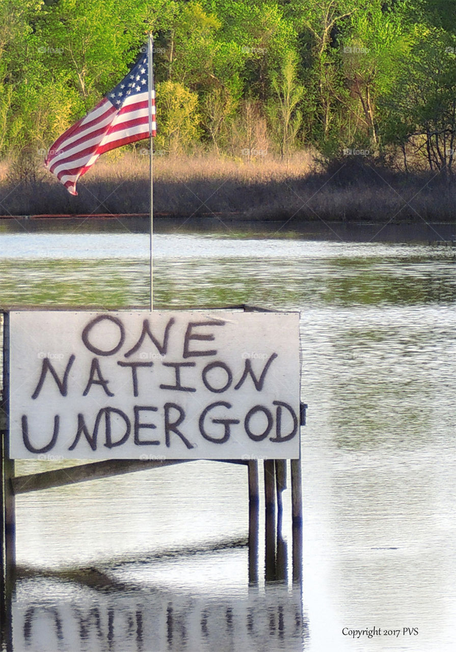 fishing dock on lake with u.s. flag