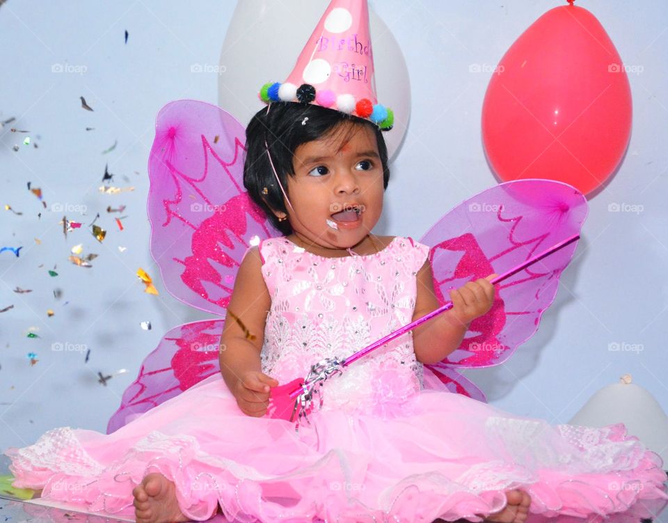 Cute baby in fairy costume celebrating her birthday